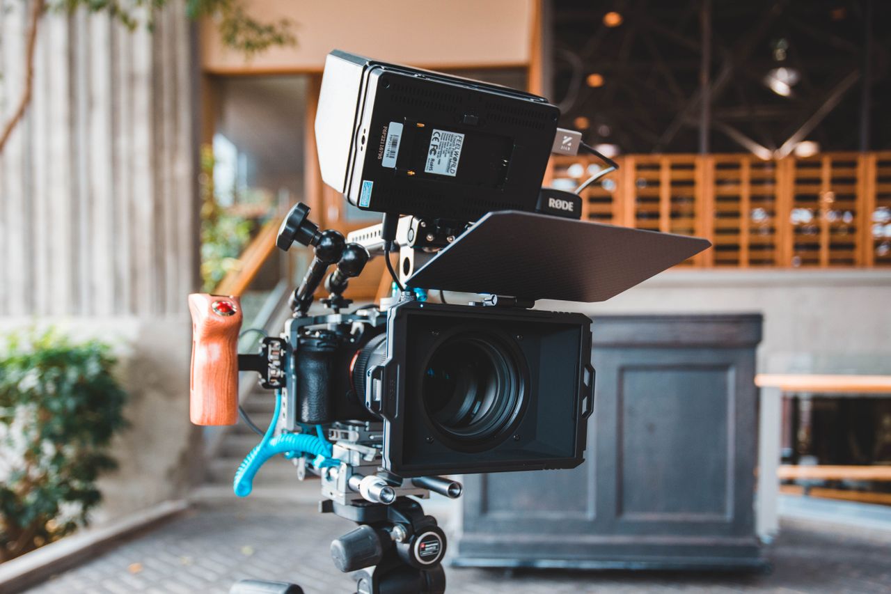 Home Close-up of a modern camera setup with a Rode monitor in a studio setting.