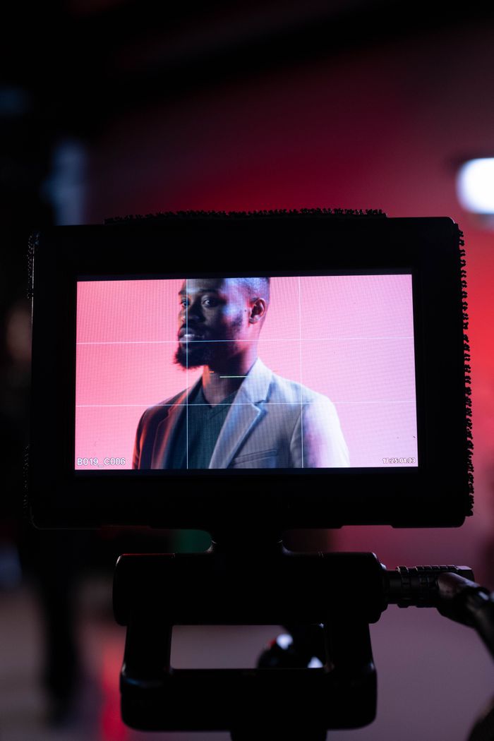 Home Portrait of a man on a monitor, capturing a behind-the-scenes film production moment.